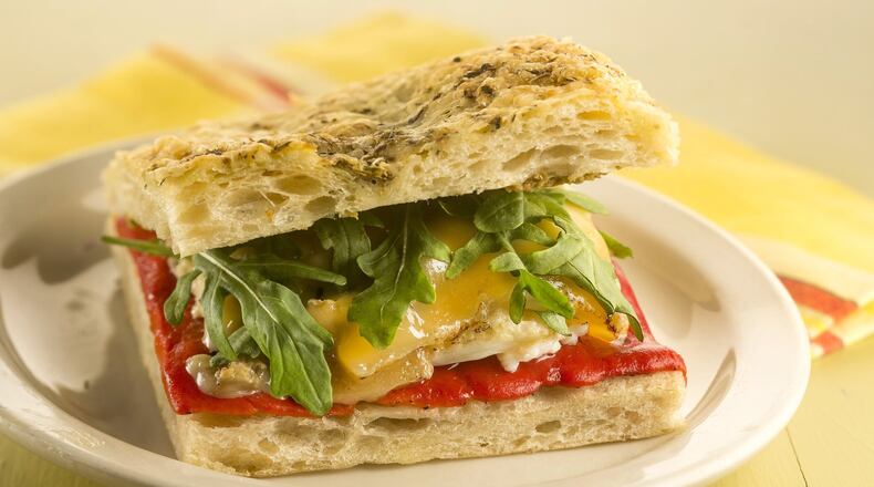 This twist on a pepper and egg sandwich has all the elements of the traditional version, but also adds olive tapenade, cheese and fresh arugula. (Bill Hogan/Chicago Tribune/TNS)