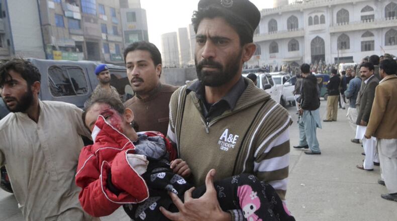 A young Pakistani girl, victim of a terrorist attack, is rushed to a hospital in Peshawar. (AP)