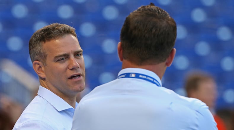 Chicago Cubs President of Baseball Operations Theo Epstein, left, looks on before the start of a game against the Miami Marlins at Marlins Park in Miami on Friday, March 30, 2018. (David Santiago/El Nuevo Herald/TNS)