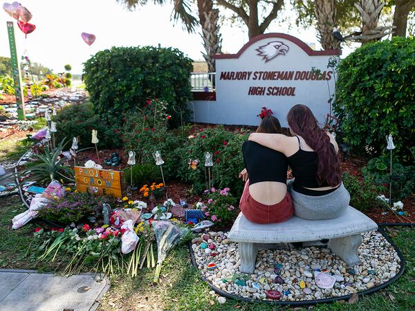 Mourners visit a makeshift memorial outside of Marjory Stoneman Douglas High School in Parkland, Florida, on Feb. 14, 2020. (Matias J. Ocner/Miami Herald/TNS)