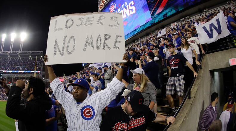 Fan react after the Chicago Cubs won Game 7 of the Major League Baseball World Series against the Cleveland Indians Thursday, Nov. 3, 2016, in Cleveland. The Cubs won 8-7 in 10 innings to win the series 4-3. (AP Photo/Charlie Riedel)