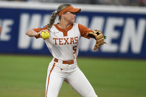 Texas utility player Kaydee Bennett throws to first during the first game of the NCAA softball Women's College World Series finals against Texas Tech in Oklahoma City, Wednesday, June 4, 2025. (AP Photo/Kyle Phillips)