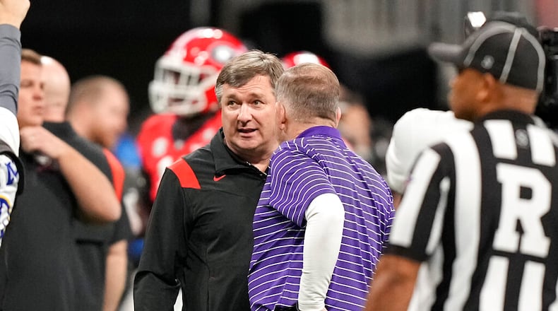 LSU head coach Brian Kelly and Georgia head coach Kirby Smart meet before the Southeastern Conference championship NCAA college football game, Saturday, Dec. 3, 2022, in Atlanta. (Brynn Anderson/AP)