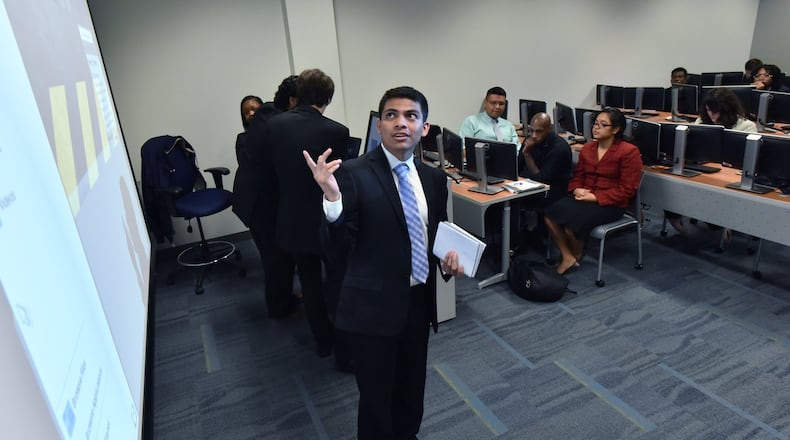 Juan Isidor-Mendoza gives a final group presentation in front of other Year Up Atlanta participants at Gwinnett Technical College. Year UP has trained hundreds of disadvantaged young men and women, teaching them business skills, giving them internships and moving them into jobs. HYOSUB SHIN / HSHIN@AJC.COM