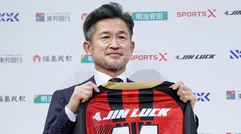 Japanese soccer player Kazuyoshi Miura poses with uniform of third-division J-League team Fukushima United. during a press conference in Tokyo, Japan, on Jan. 9, 2026. (Yuya Shino/Kyodo News via AP)