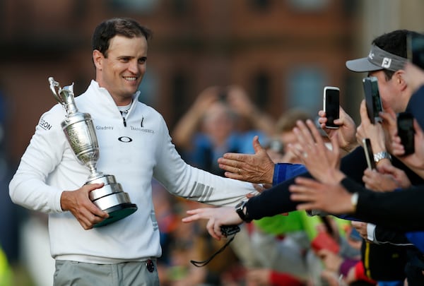 FILE -United States' Zach Johnson celebrates with members of the public as he holds the trophy after winning a playoff after the final round at the British Open Golf Championship at the Old Course, St. Andrews, Scotland, Monday, July 20, 2015.(AP Photo/Jon Super, File)