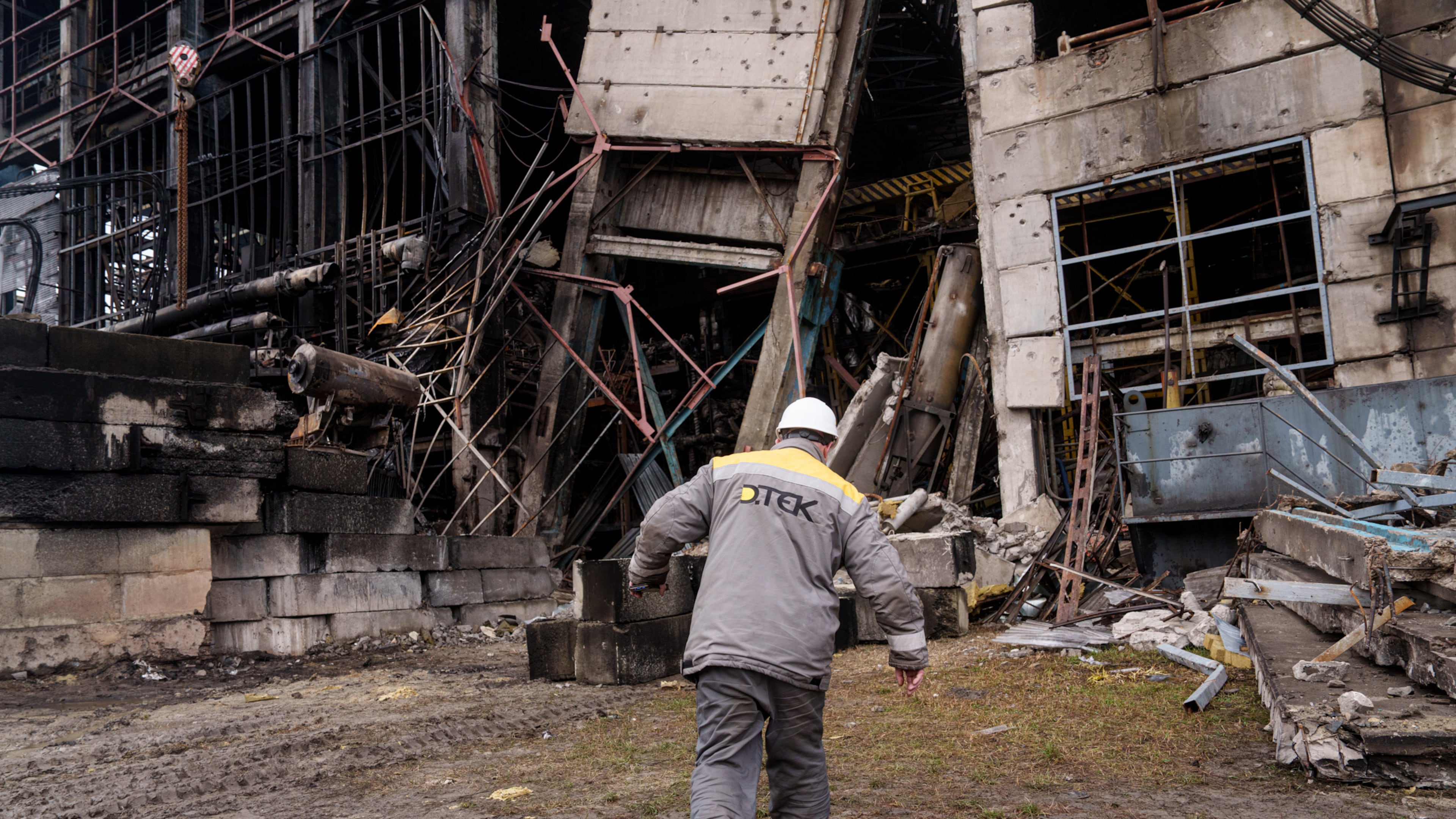 A worker walks in front of a production hall after a recent Russian missile attack at DTEK's power plant in Ukraine, on Wednesday, Dec. 10, 2025. (AP Photo/Evgeniy Maloletka)