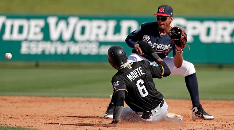 Pittsburgh Pirates' Starling Marte (6) steals second base ahead of the throw to Atlanta Braves shortstop Johan Camargo during the sixth inning Monday,March 5, 2018, in Lake Buena Vista, Fla.