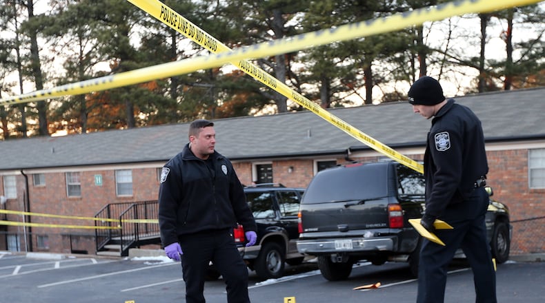 Marietta Police investigate the scene of a shooting Thursday afternoon January 30, 2014 at the Wynridge Apartments.