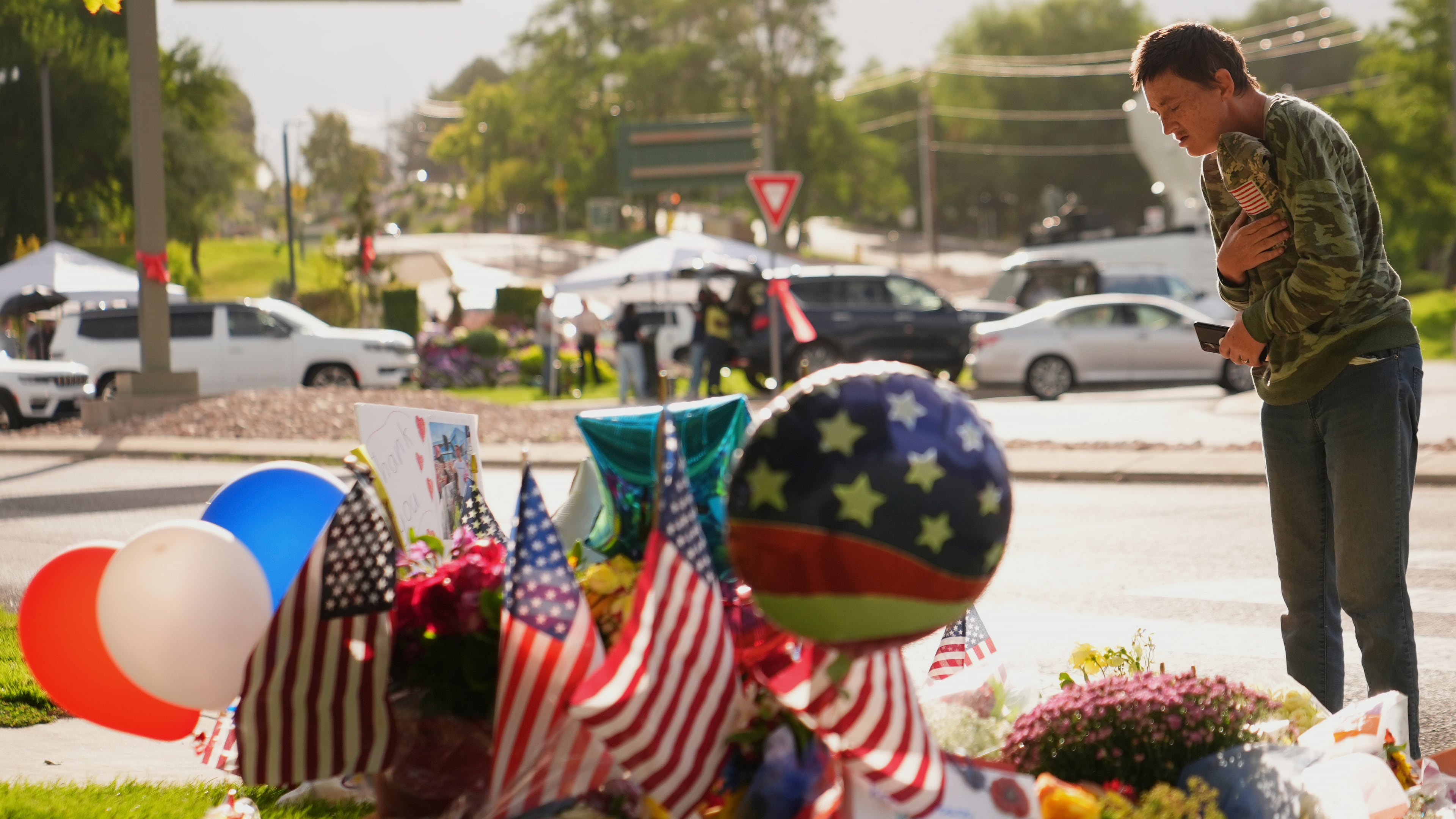 Wendy Lucas, a Utah Valley University student, looks at a memorial set up for Charlie Kirk at Utah Valley University in Orem, Utah, Friday, Sept. 12, 2025. (AP Photo/Lindsey Wasson)