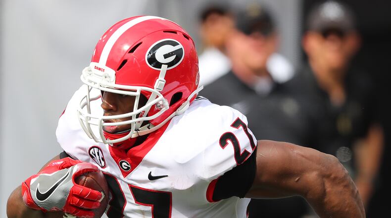 Power personified: Georgia tailback Nick Chubb runs for his second touchdown of the first half to take a 21-0 lead over Vanderbilt. Curtis Compton/ccompton@ajc.com