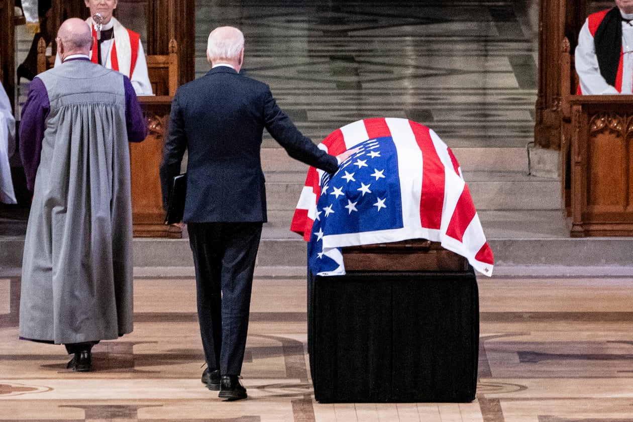 President Joe Biden touches the casket of former President Jimmy Carter before speaking during a state funeral for Carter at the National Cathedral, Thursday, Jan. 9, 2025, in Washington. (Haiyun Jiang/The New York Times via AP, Pool)