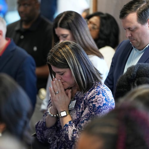 Attendees pray at the conclusion of a news conference about the children killed during a mass shooting the day before in Shreveport, La., Monday, April 20, 2026. (AP Photo/Gerald Herbert)