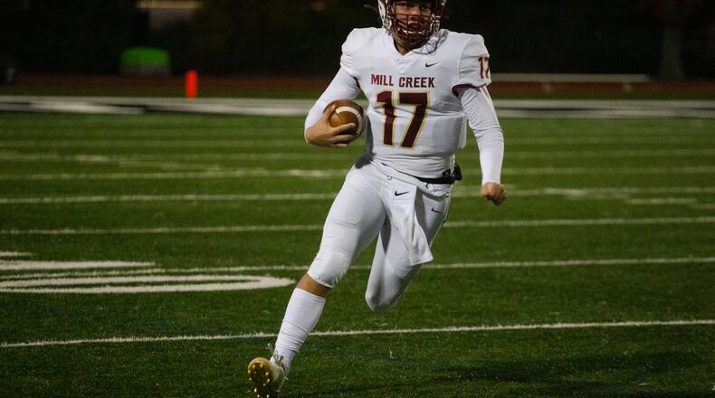 Hayden Clark, sophomore quarterback for Mill Creek, runs the ball
during the Mill Creek vs. Roswell high school football game on Friday, November 27, 2020, at Roswell High School in Roswell, Georgia. Mill Creek led Roswell 27-21 at the end of the third quarter. CHRISTINA MATACOTTA FOR THE ATLANTA JOURNAL-CONSTITUTION