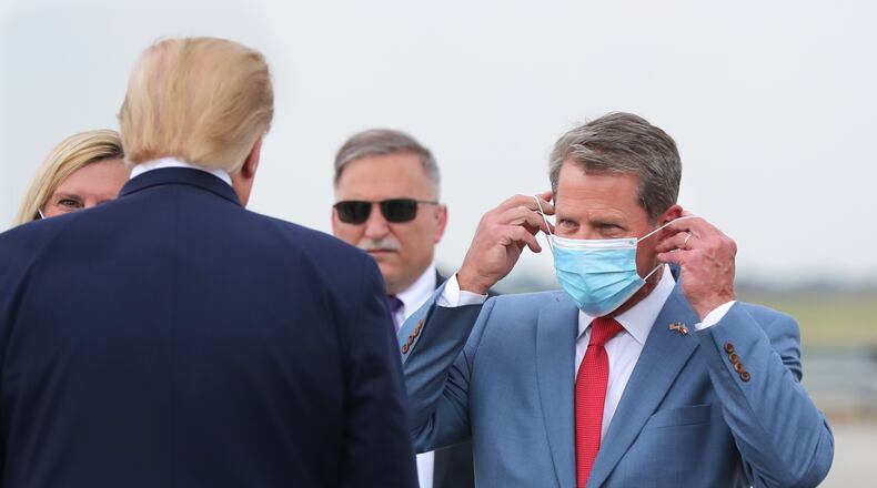 Georgia Gov. Brian Kemp, right, greets President Donald Trump as he visits Georgia to talk about an infrastructure overhaul at the UPS Hapeville hub at Hartsfield-Jackson International Airport in Atlanta on Wednesday, July 15, 2020. (Curtis Compton/Atlanta Journal-Constitution)