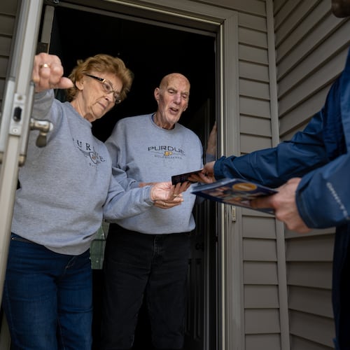 Retired couple Annette Williams, and her husband, Curtis Williams, speak with Indiana state Sen. Spencer Deery, R-West Lafayette, who represents District 23, after he stops at their home while canvassing a neighborhood, Saturday, April 11, 2026, in West Lafayette, Ind. (AP Photo/Doug McSchooler)