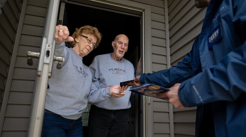 Retired couple Annette Williams, and her husband, Curtis Williams, speak with Indiana state Sen. Spencer Deery, R-West Lafayette, who represents District 23, after he stops at their home while canvassing a neighborhood, Saturday, April 11, 2026, in West Lafayette, Ind. (AP Photo/Doug McSchooler)