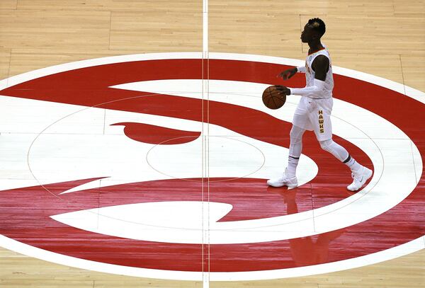 Hawks guard Dennis Schroder moves the ball down court while playing the Utah Jazz at Philips Arena.   Curtis Compton/ccompton@ajc.com