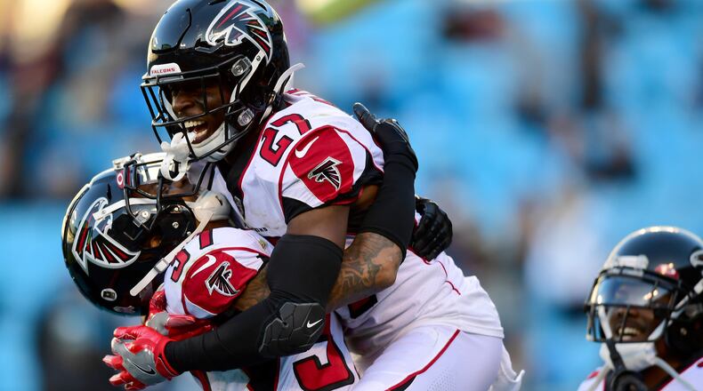 Falcons safeties Damontae Kazee (27) and Ricardo Allen celebrate after the team's fourth interception against the Carolina Panthers Sunday, Nov. 17, 2019, at Bank of America Stadium in Charlotte. Atlanta won 26-9.