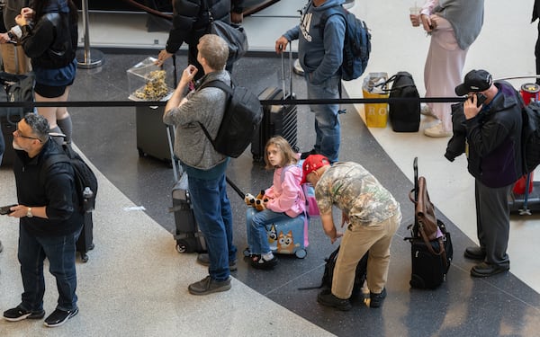 Travelers wait in multihour lines Friday for domestic security at Hartsfield-Jackson Atlanta International Airport amid the ongoing partial goverment shutdown. (Ben Hendren for the AJC)