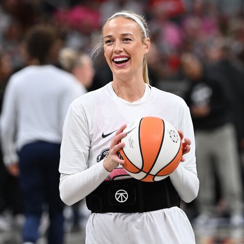Indiana Fever guard Sophie Cunningham smiles while warming up before a WNBA basketball game against the Connecticut Sun, Friday, Aug. 28, 2026, in Indianapolis. (AP Photo/Marc Lebryk)