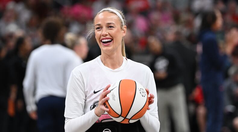 Indiana Fever guard Sophie Cunningham smiles while warming up before a WNBA basketball game against the Connecticut Sun, Friday, Aug. 28, 2026, in Indianapolis. (AP Photo/Marc Lebryk)