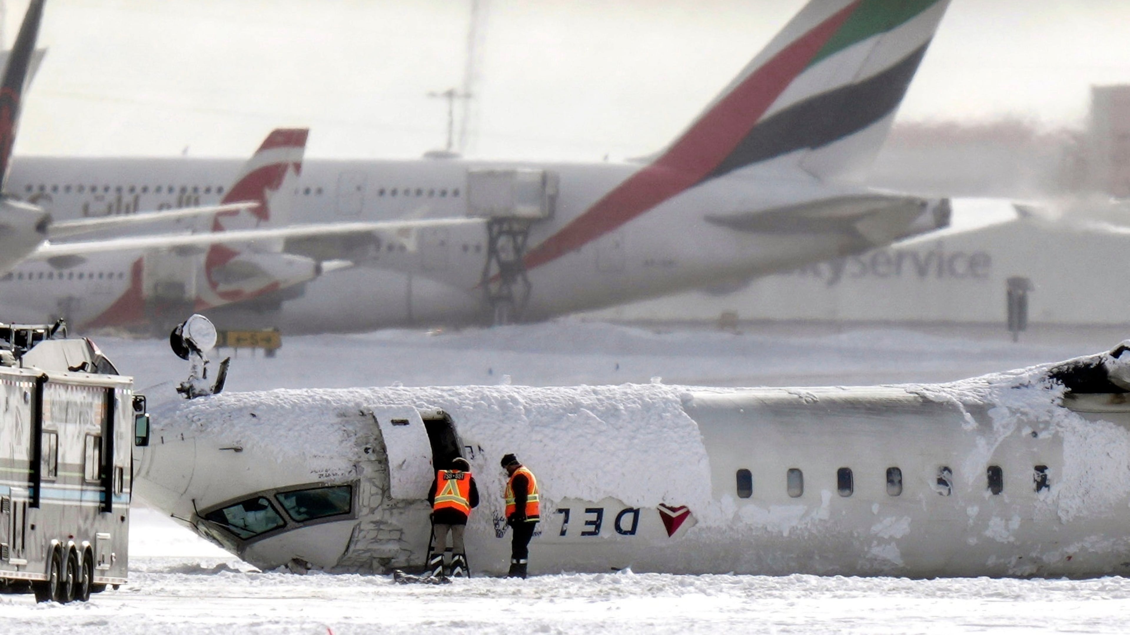 A Delta Air Lines plane lies upside down at Toronto Pearson International Airport on Tuesday, Feb. 18, 2025, after it crash-landed. (Chris Young/The Canadian Press via AP)
