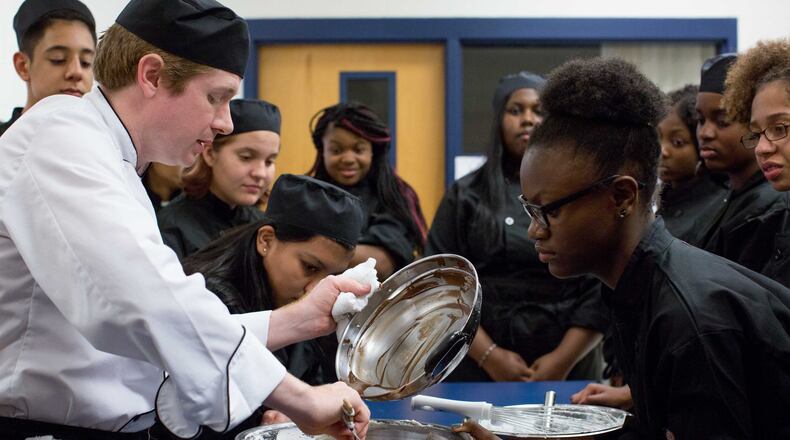 Mundy’s Mill High School teacher Kenneth Hosley pours chocolate into a bowl during a cooking class, Tuesday, Sept. 6, 2016, in Jonesboro, Ga. Hosley started a culinary arts club at his school because many of his students were interested in working in restaurants after graduation, but their high school didn’t have a culinary arts program. BRANDEN CAMP/SPECIAL