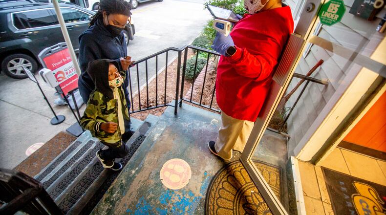 Lasharia Chambers (left) drops off her daughter Issac Gloster, 4, at the Little Ones Learning Center in Forest Park Friday morning, March 19, 2021. (Steve Schaefer for The Atlanta Journal-Constitution)