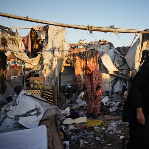 Displaced Palestinians inspect the damage after an Israeli army strike on their tent camp in Deir al-Balah, Gaza Strip, Wednesday, Oct. 29, 2025. (AP Photo/Abdel Kareem Hana)