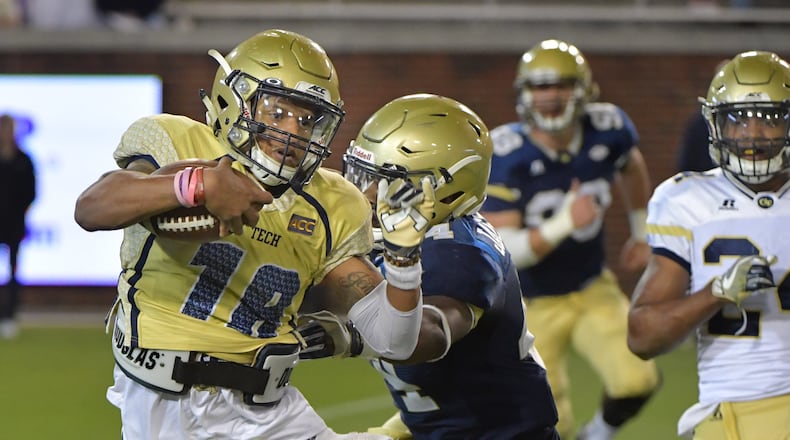 Jackets QB Tobias Oliver (18) runs past Quez Jackson (44) during Georgia Tech's spring football game Friday at Bobby Dodd Stadium. (Hyosub Shin/hshin@ajc.com)