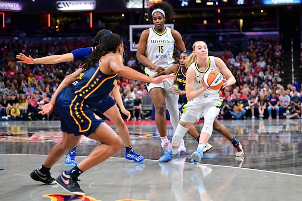 Dallas Wings' Paige Bueckers (5) makes a pass during the first half of a WNBA basketball game against the Indiana Fever, Sunday, July 13, 2025, in Indianapolis. (AP Photo/Doug McSchooler)