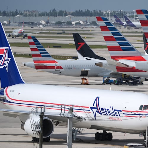 Jets sit parked on the tarmac at Miami International Airport, Monday, Nov. 10, 2025, in Miami. (AP Photo/Rebecca Blackwell)