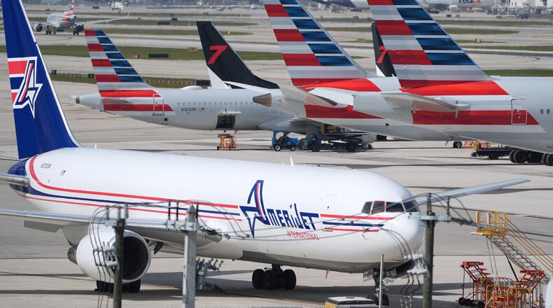 Jets sit parked on the tarmac at Miami International Airport, Monday, Nov. 10, 2025, in Miami. (AP Photo/Rebecca Blackwell)
