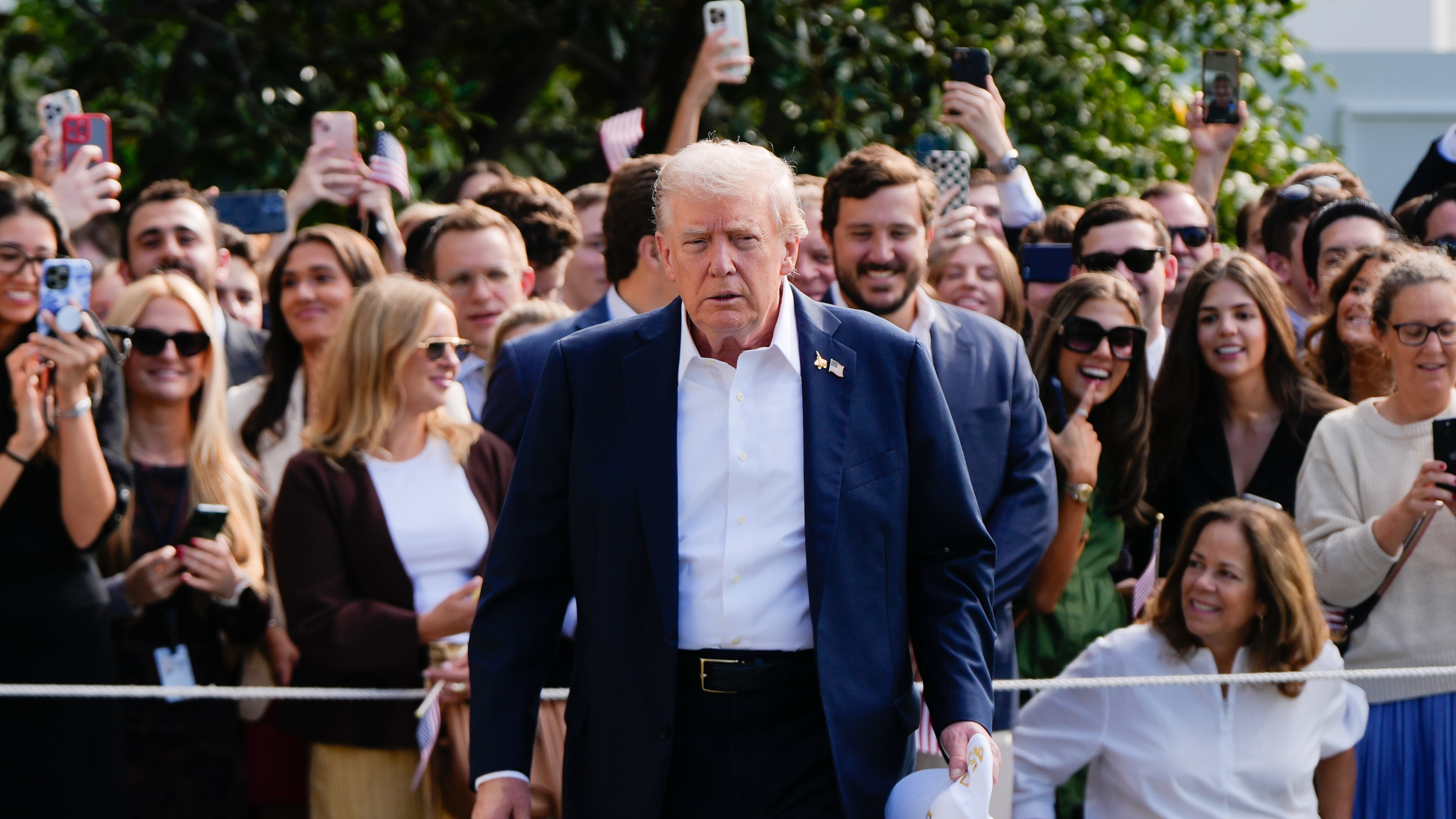 President Donald Trump walks to speak with reporters after greeting supporters before departing the White House, Friday, Sept. 26, 2025, in Washington. (AP Photo/Julia Demaree Nikhinson)