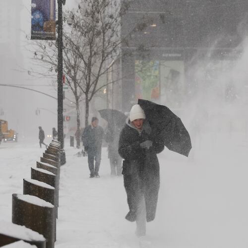 Pedestrians walk down Fifth Avenue during a winter storm, Sunday, Jan. 25, 2026, in New York. (AP Photo/Heather Khalifa)