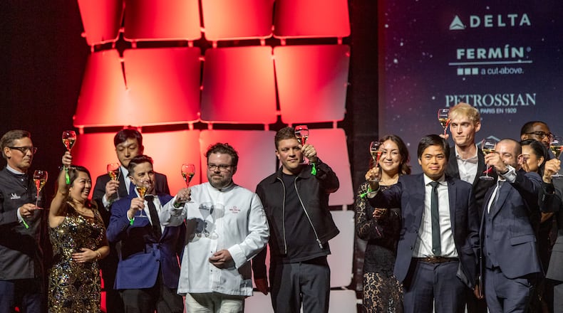 The Michelin Guide Awards take place at the Georgia World Congress Center on Monday, Oct 28, 2024. Michelin stars were awarded to Staplehouse Executive Chef Ryan Smith, center in white jacket, who celebrates with chefs who kept their stars this year and the other honorees, including O By Brush Executive Chef Jason Liang; Omakase Table Executive Chef Leonard Yu and Spring Executive Chef Brian So. (Jenni Girtman for The Atlanta Journal-Constitution)