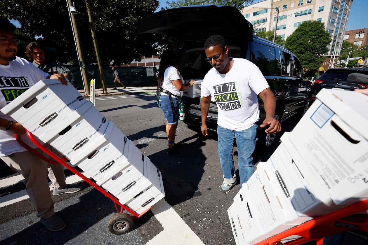 Forest defenders assisted in unloading sixteen boxes containing more than 100,000 signatures from a petition, on Sept. 10, 2023. (Miguel Martinez/The Atlanta Journal-Constitution/TNS)