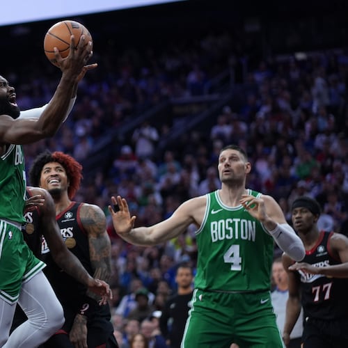 Boston Celtics' Jaylen Brown, left, goes up for a shot past Philadelphia 76ers' Kelly Oubre Jr. during the first half of Game 3 in a first-round NBA playoffs basketball series Friday, April 24, 2026, in Philadelphia. (AP Photo/Matt Slocum)