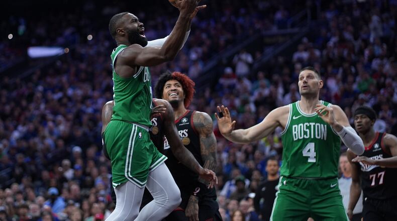 Boston Celtics' Jaylen Brown, left, goes up for a shot past Philadelphia 76ers' Kelly Oubre Jr. during the first half of Game 3 in a first-round NBA playoffs basketball series Friday, April 24, 2026, in Philadelphia. (AP Photo/Matt Slocum)