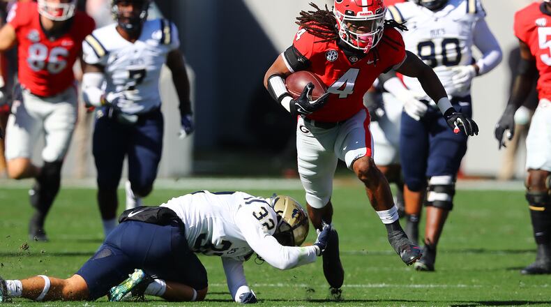 Georgia running back James Cook breaks off a 40-yard run against Charleston Southern during the first quarter Saturday, Nov. 20, 2021, in Athens.  (Curtis Compton / Curtis.Compton@ajc.com)
