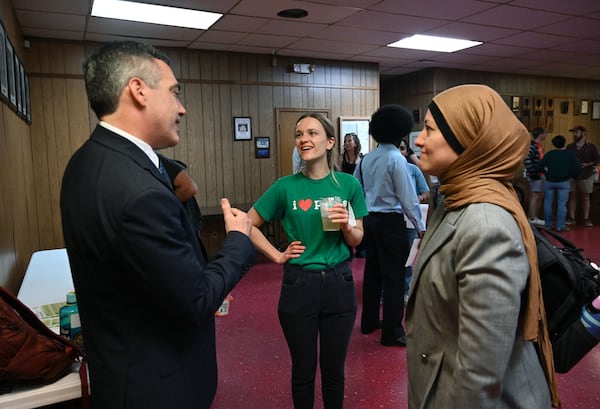 Atlanta City Council member Kelsea Bond (center) chats with Peter Hubbard, a Georgia Public Service commissioner, and state Rep. Ruwa Romman prior to a data center town hall at the Communication Workers of America on Thursday, Sept. 10, 2026, in Atlanta. (Hyosub Shin/AJC)