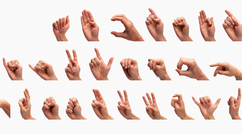 Hands demonstrating the complete US manual alphabet, gesturing the letters 'A' to 'Z', front view.