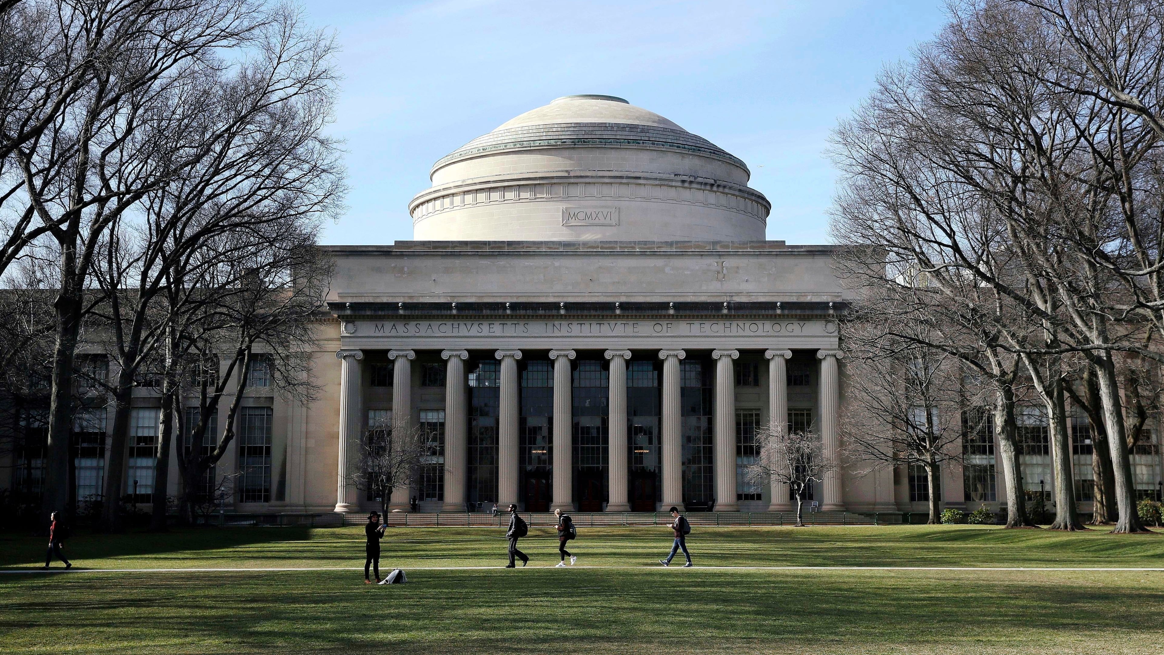 FILE - Students walk past the "Great Dome" atop Building 10 on the Massachusetts Institute of Technology campus in Cambridge, Mass, April 3, 2017. (AP Photo/Charles Krupa, File)