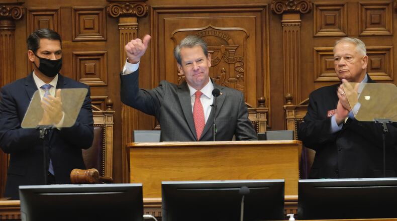 Lt. Gov. Geoff Duncan, left, and House Speaker David Ralston, right, welcome  Gov. Brian Kemp for his annual State of the State address to the Georgia Assembly on Thursday, Jan. 13, 2022. (Ben Gray for The Atlanta Journal-Constitution)