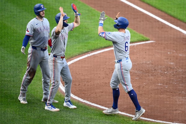 Texas Rangers' Josh Jung (6) celebrates his two-home run with Evan Carter, center, and Jonah Heim, left, during the fourth inning of a baseball game against the Baltimore Orioles, Wednesday, June 25, 2025, in Baltimore. (AP Photo/Nick Wass)