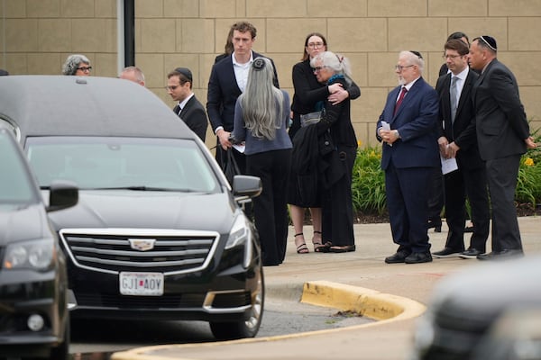 Family and friends gather outside Congregation Beth Torah after a funeral for Sarah Milgrim, a staffer at the Israeli Embassy who was killed last week outside a Washington Jewish museum, Tuesday, May 27, 2025, in Overland Park, Kan. (AP Photo/Charlie Riedel)