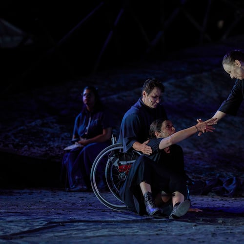 From left to right, Eirini Kourouvani, a wheelchair dancer, Evi Saoulidou and Lydia Fotopoulou perform during a dress rehearsal of Euripides' tragedy The Trojan Women, staged by the National Theatre of Greece, at the Ancient Theater of Epidaurus, Greece, on Thursday, July 30, 2026. (AP Photo/Petros Giannakouris)