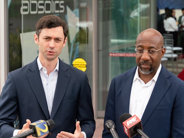 Georgia Sens. Jon Ossoff (left) and Raphael Warnock — along with the other 45 members in the Democratic caucus — opposed the reconciliation bill that passed the Senate on Tuesday. The wide-ranging package extends tax cuts and slashes federal spending on safety net programs.
