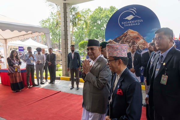 Nepalese Prime Minister Khadga Prasad Oli, center, arrives to participate in an environment conference named Sagarmatha Sambaad (Mount Everest Dialogue) in Kathmandu, Nepal, Friday, May 16, 2025. (AP Photo/Niranjan Shrestha)
